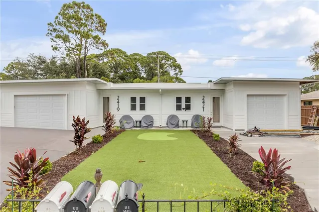 a view of a house with swimming pool and furniture