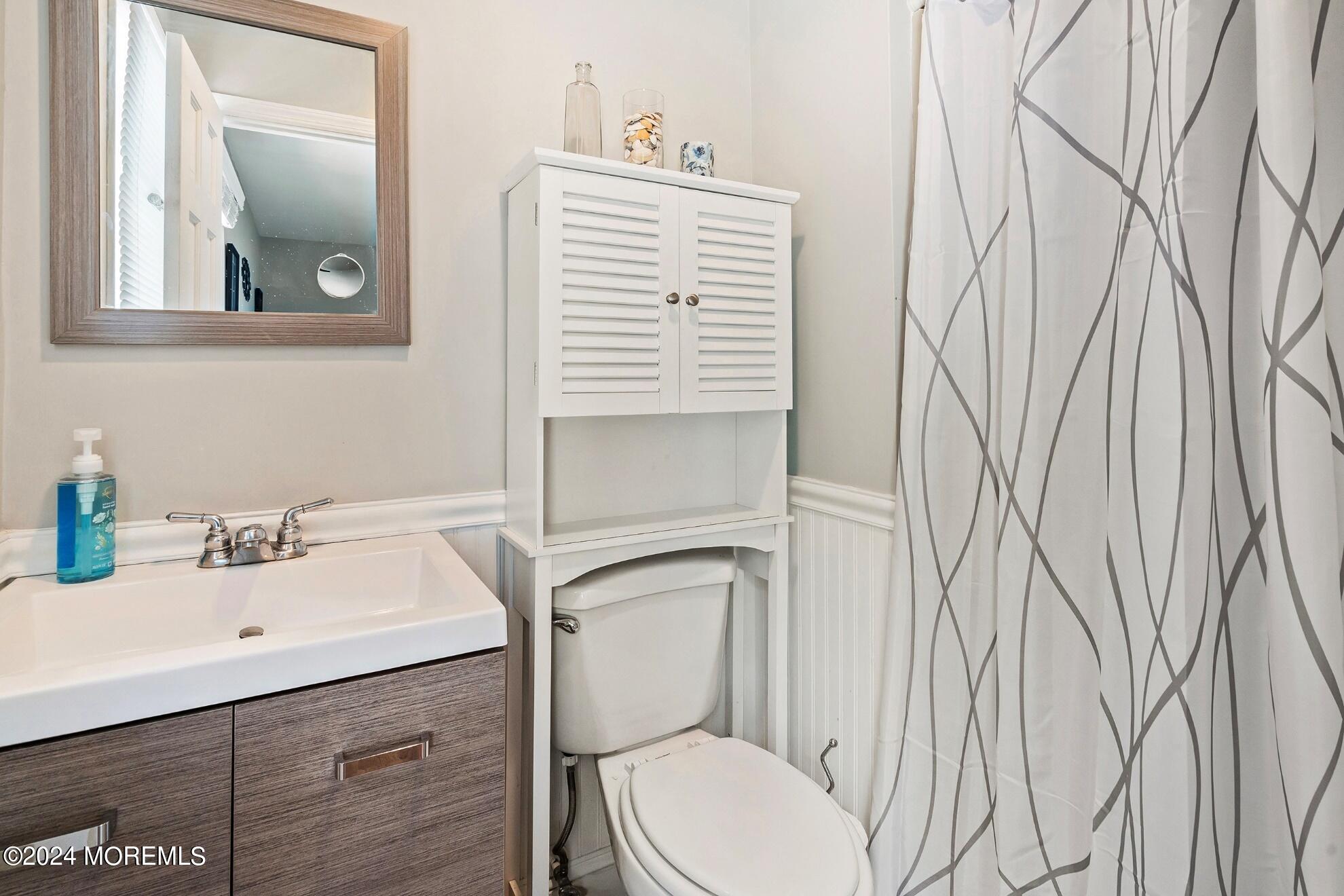 5 Adams Drive Brick, NJ 08724 - Photo 14 of 15 a bathroom with a sink a toilet and mirror