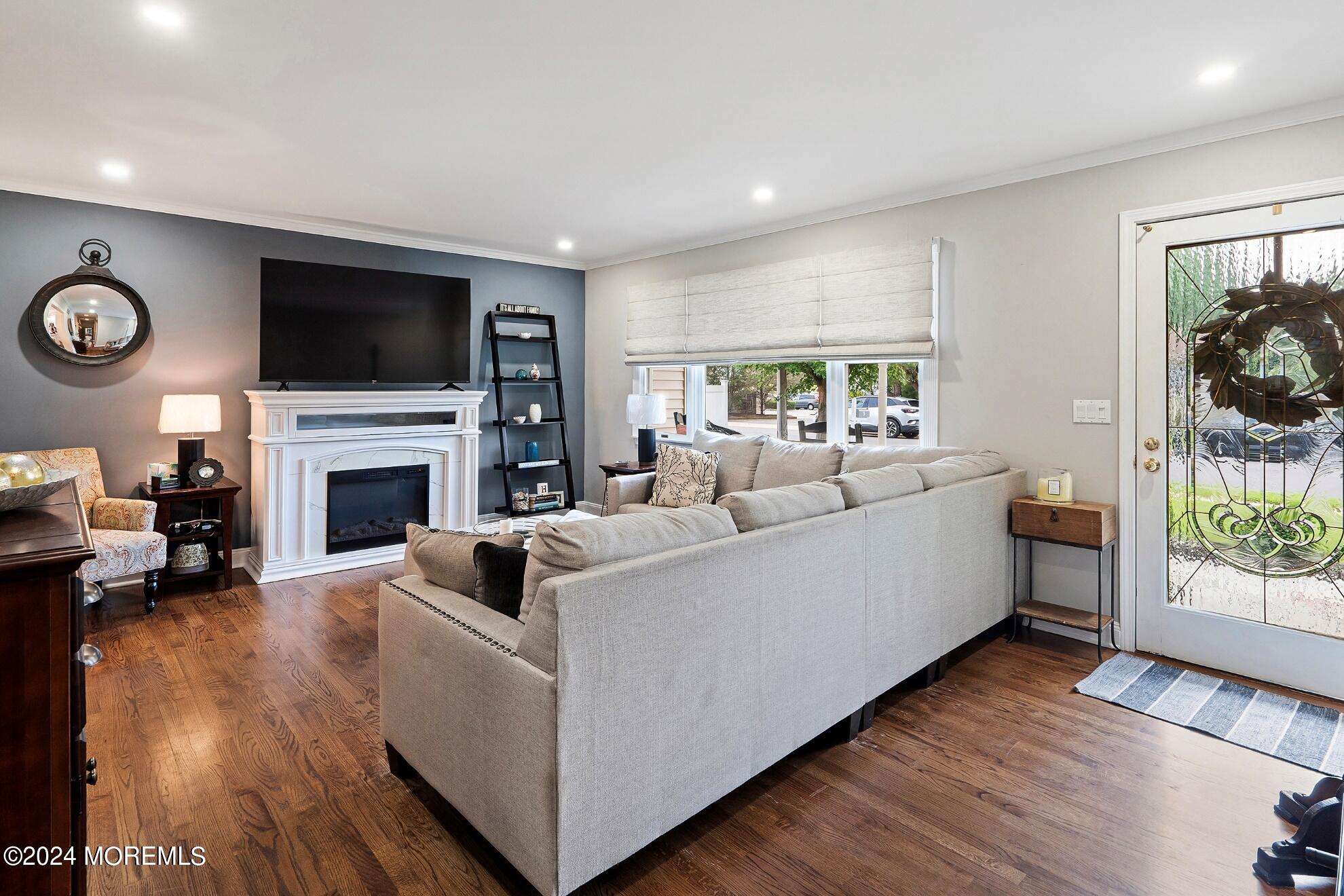 5 Adams Drive Brick, NJ 08724 - Photo 4 of 15 a living room with furniture a flat screen tv and a fireplace