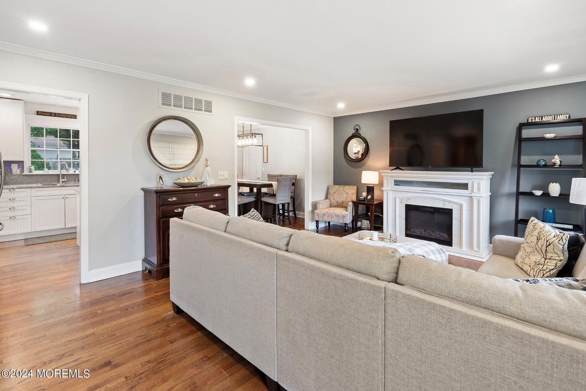 5 Adams Drive Brick, NJ 08724 - Photo 5 of 15 a living room with furniture a flat screen tv and a fireplace