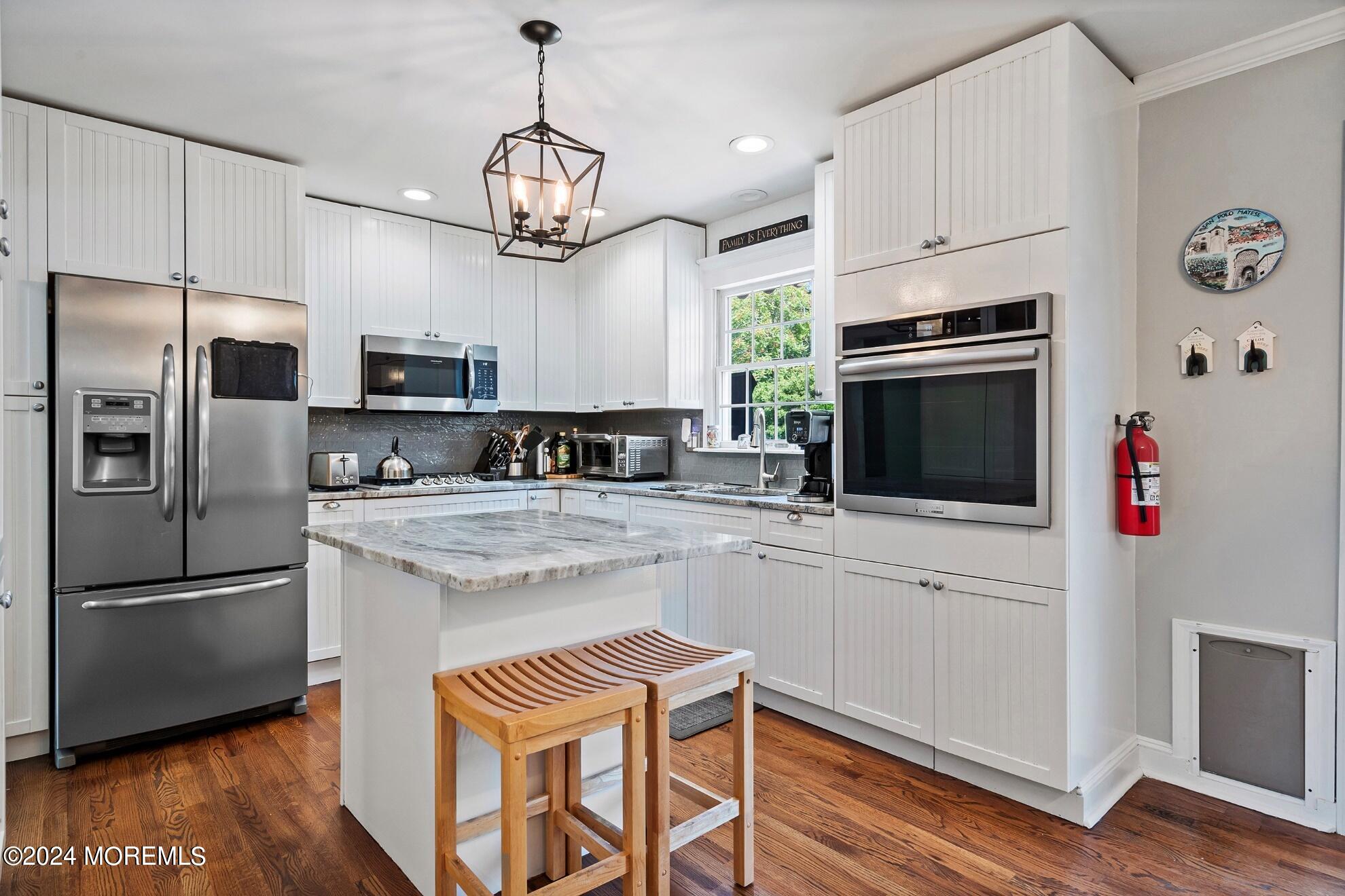 5 Adams Drive Brick, NJ 08724 - Photo 10 of 15 a kitchen with kitchen island granite countertop stainless steel appliances and wooden floor