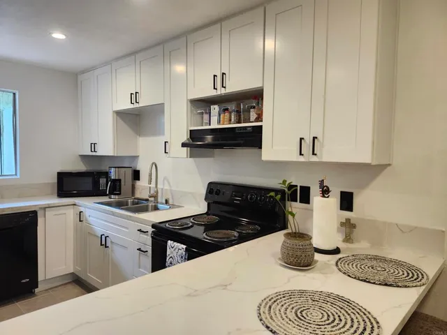 a kitchen with cabinets a sink and appliances