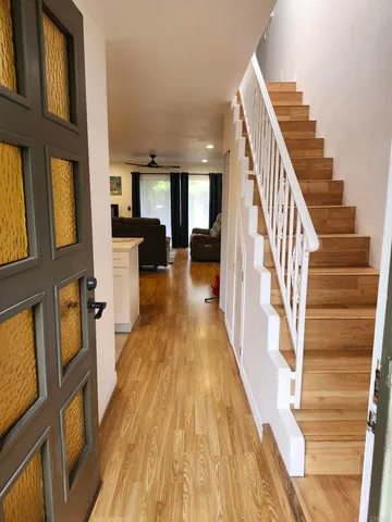 a view of a living room with furniture and wooden floor