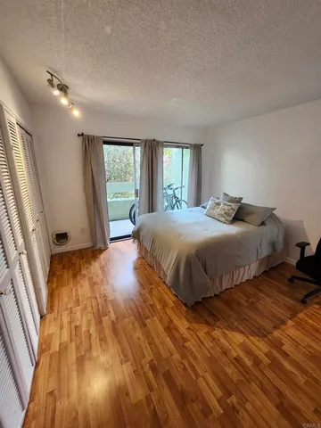 a bedroom with a bed and a large window