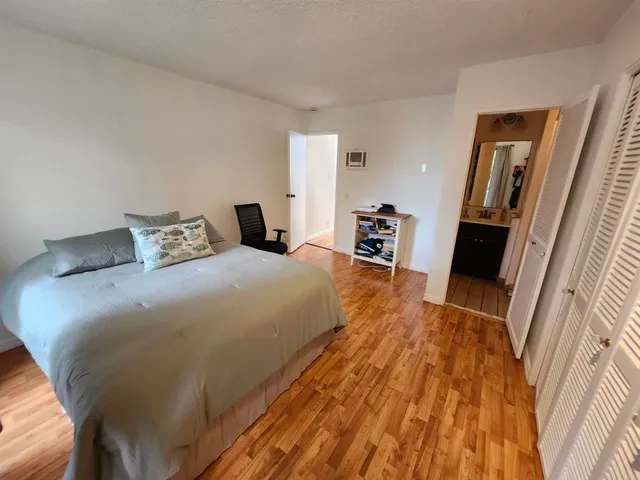 a bedroom with a bed and a large mirror