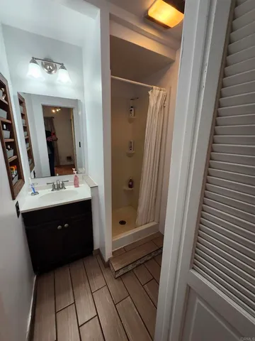 a bathroom with a sink a mirror and a shower