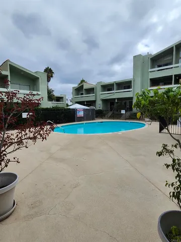 a view of backyard with barbeque grill and potted plants