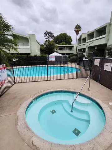 a view of a house with a swimming pool and deck
