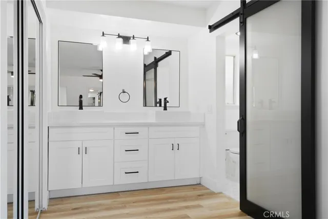 a bathroom with a double vanity sink and mirror