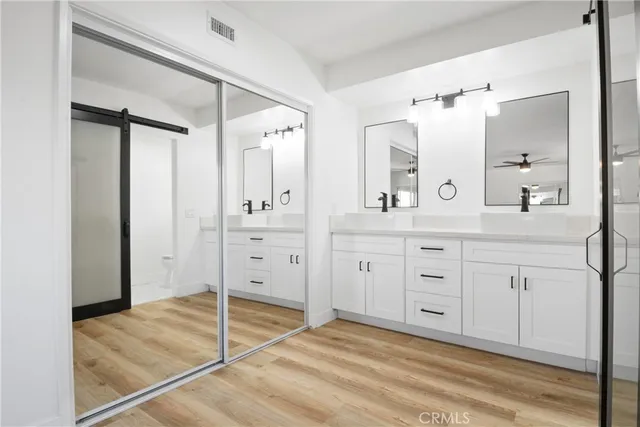 a spacious bathroom with a granite countertop sink mirror and