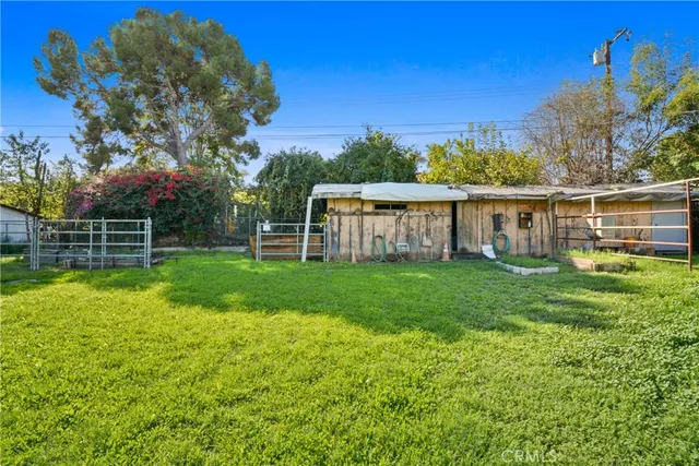 a view of a house with backyard and sitting area