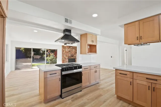 a kitchen with stainless steel appliances granite countertop a stove a sink and a refrigerator