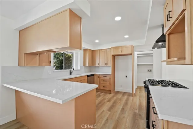 a kitchen with a sink a stove a refrigerator and a window