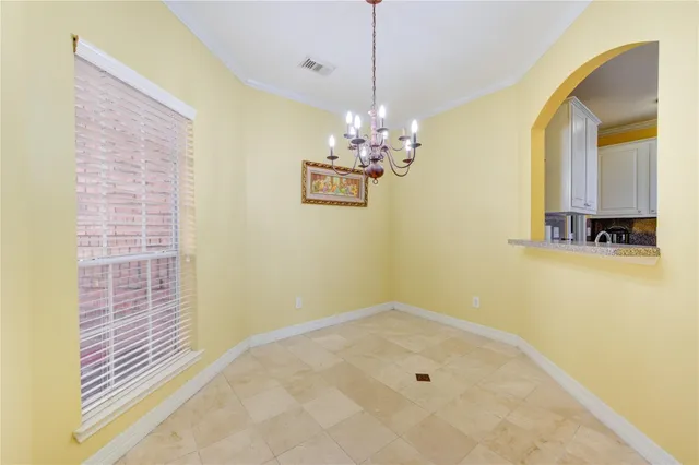 a view of a hallway with chandelier