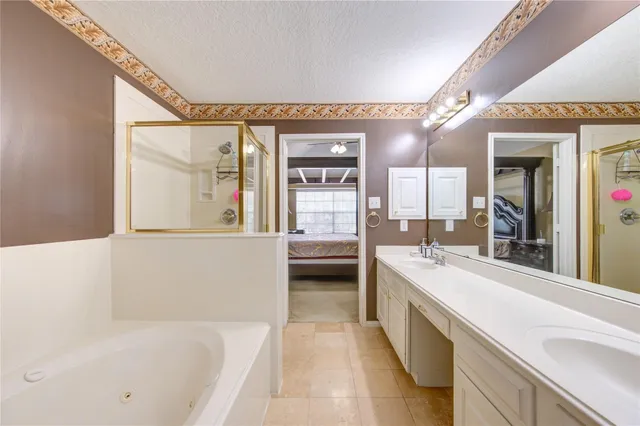 a bathroom with a double vanity sink mirror and shower