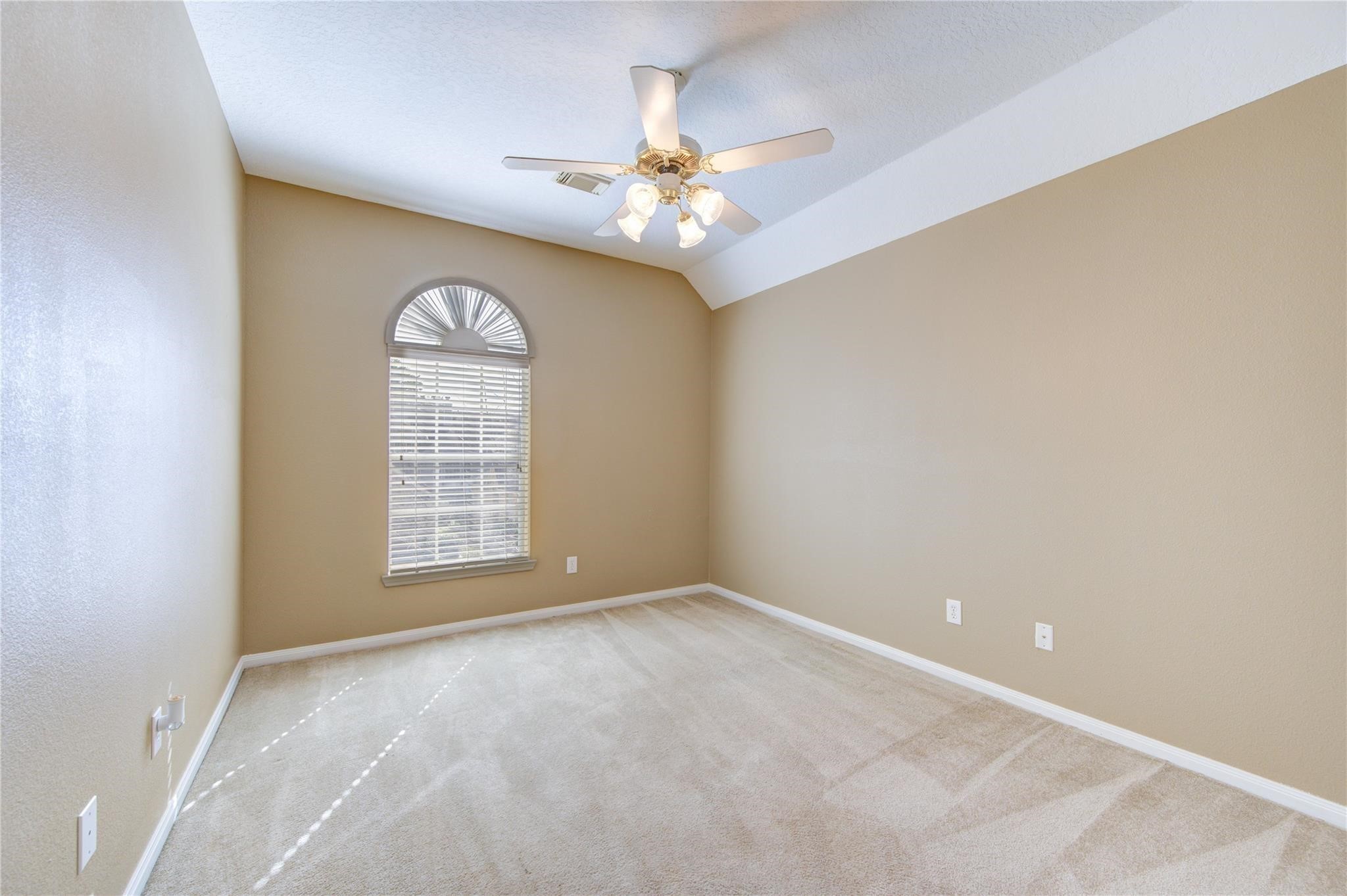 14420 Walters Road, Unit 58 Houston, TX 77014 - Photo 18 of 30 an empty room with windows and chandelier fan