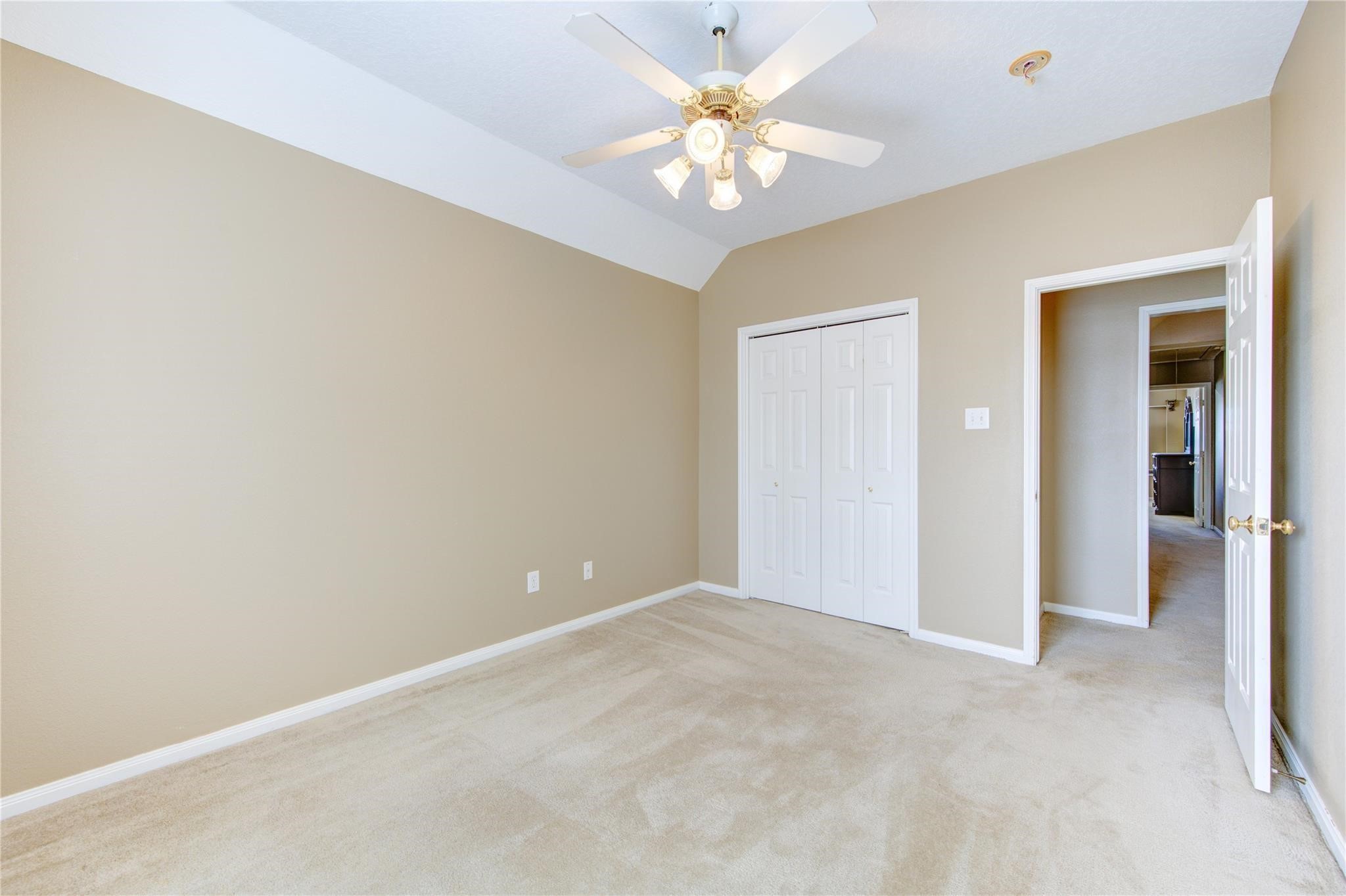 14420 Walters Road, Unit 58 Houston, TX 77014 - Photo 19 of 30 an empty room with a chandelier fan and a chandelier fan