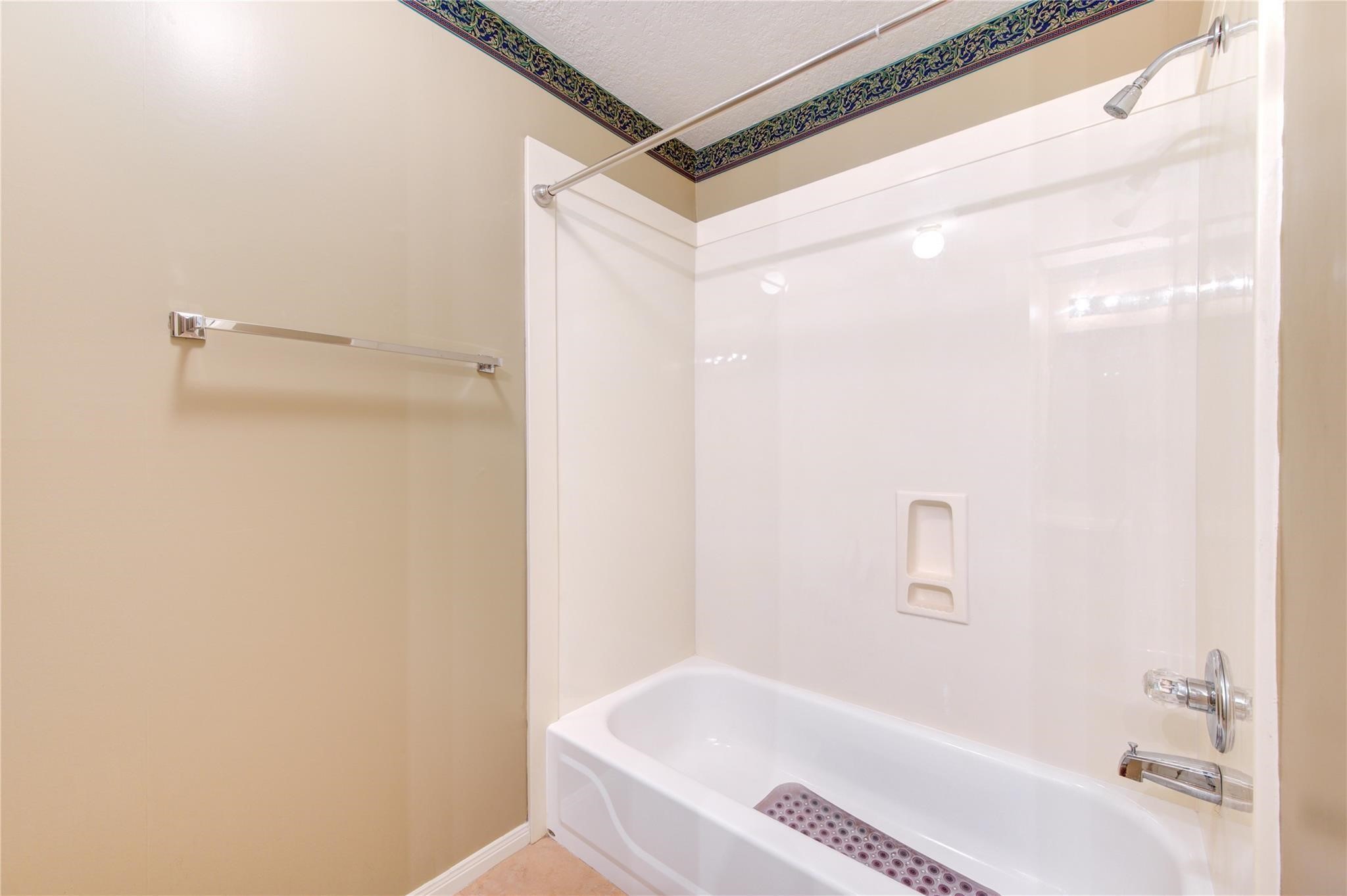 14420 Walters Road, Unit 58 Houston, TX 77014 - Photo 22 of 30 a bathroom with a bathtub and a shower