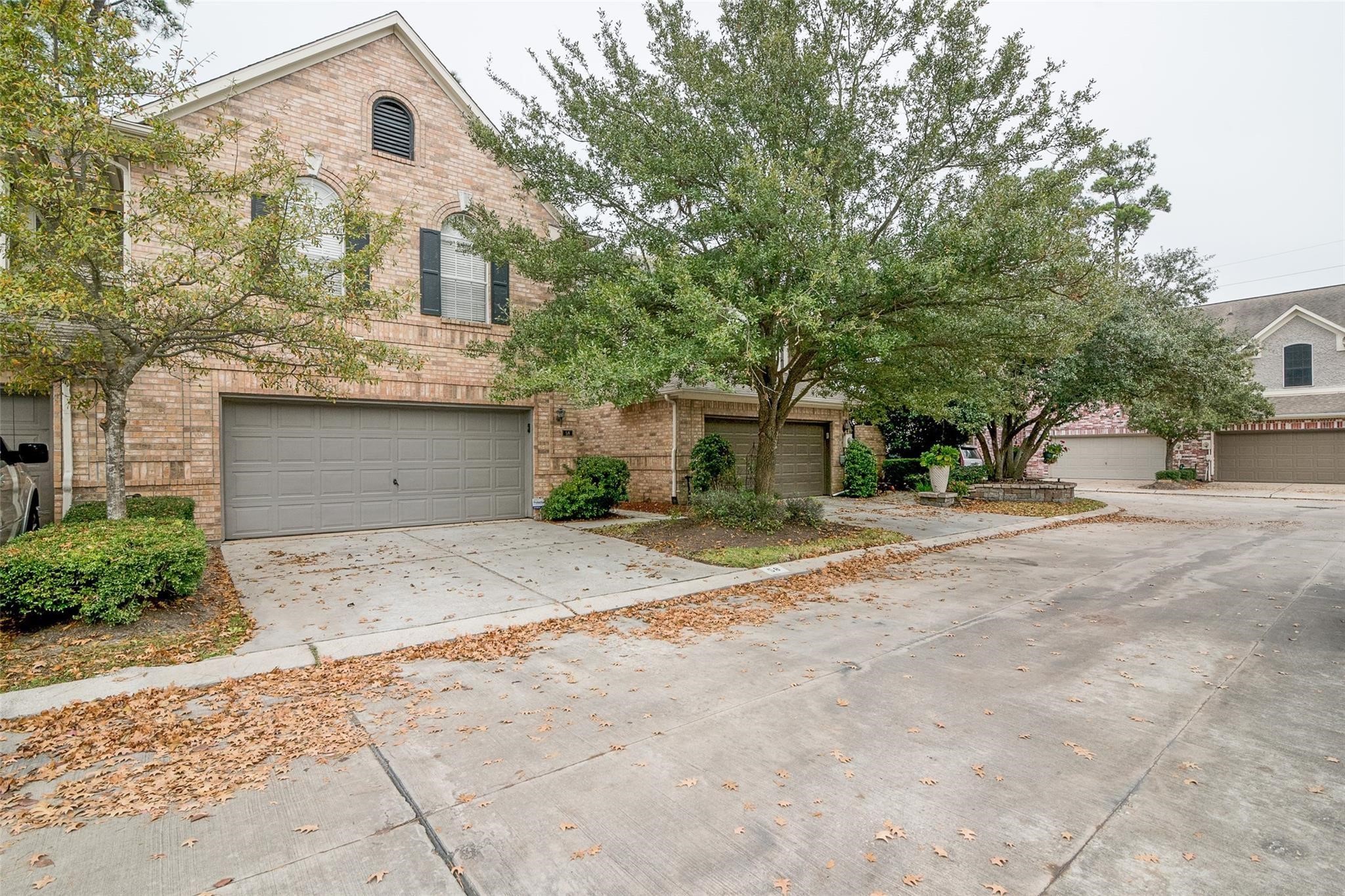 14420 Walters Road, Unit 58 Houston, TX 77014 - Photo 29 of 30 a front view of a house with a yard and garage