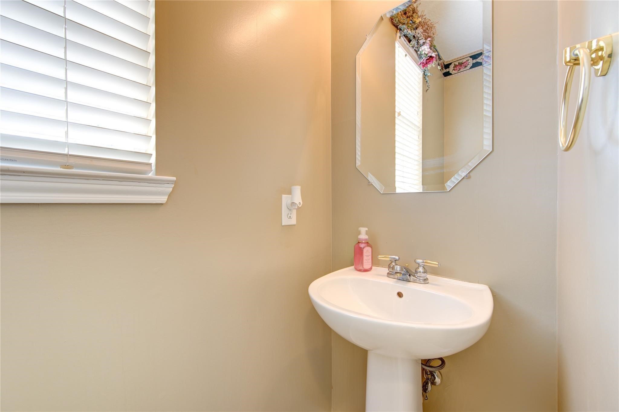 14420 Walters Road, Unit 58 Houston, TX 77014 - Photo 8 of 30 a bathroom with a sink a mirror and a window