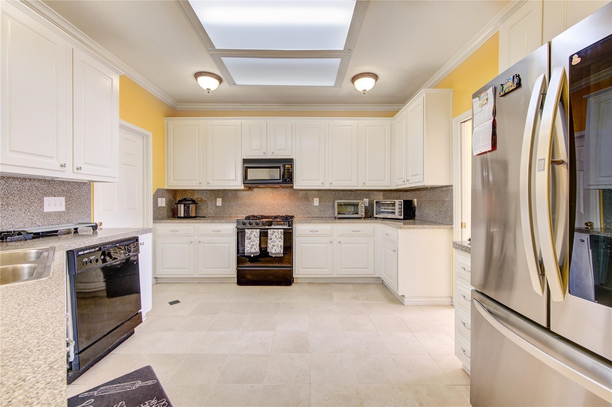14420 Walters Road, Unit 58 Houston, TX 77014 - Photo 9 of 30 a kitchen with stainless steel appliances a refrigerator sink and stove