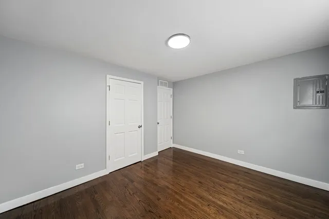 a view of a room with wooden floor and white walls