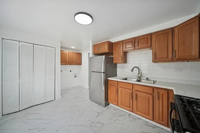 a kitchen with stainless steel appliances a refrigerator and cabinets