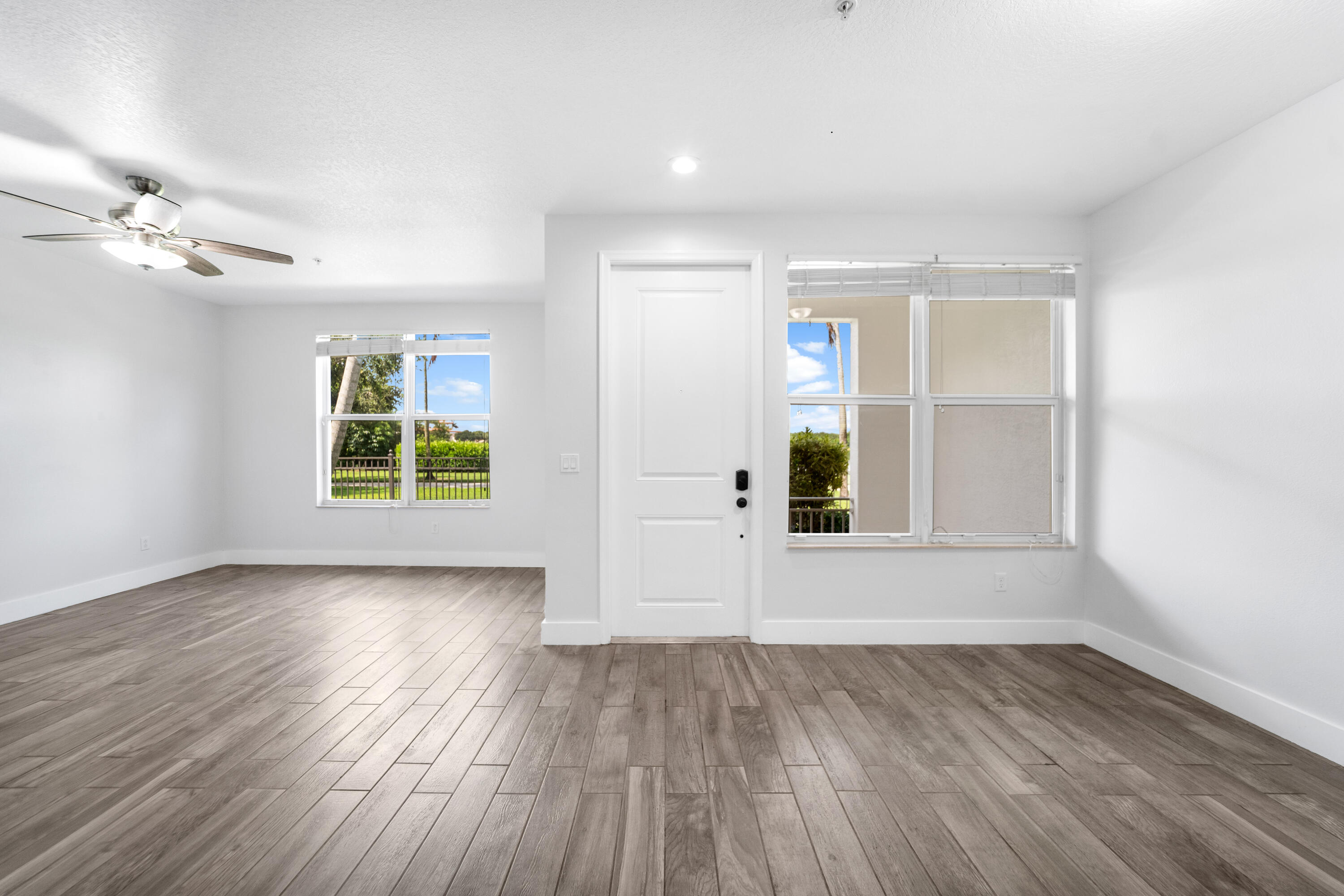 1430 Northwest 48th Lane Boca Raton, FL 33431 - Photo 10 of 54 an empty room with wooden floor and windows