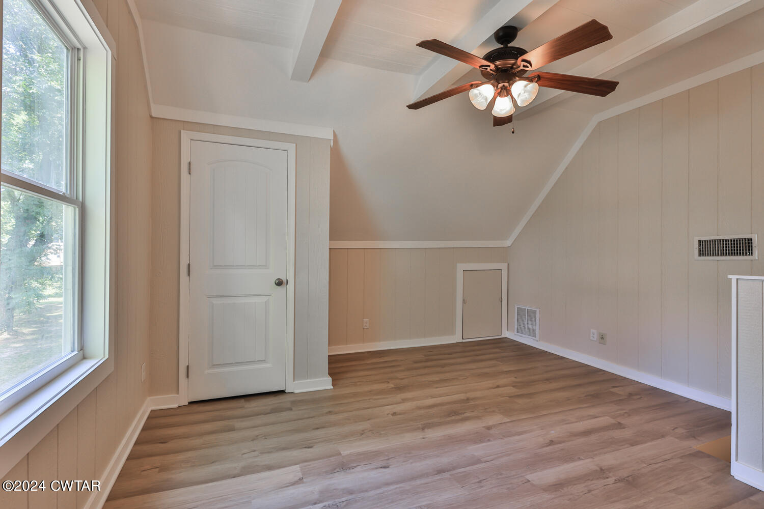 246 Thomas Street Dyer, TN 38330 - Photo 17 of 19 an empty room with wooden floor fan and windows