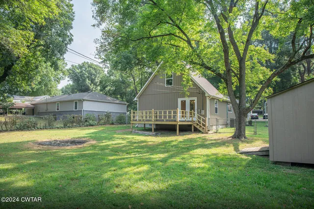 a view of a house with a yard and sitting area