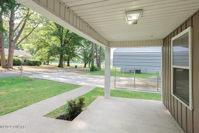 a porch with a bench in front of it