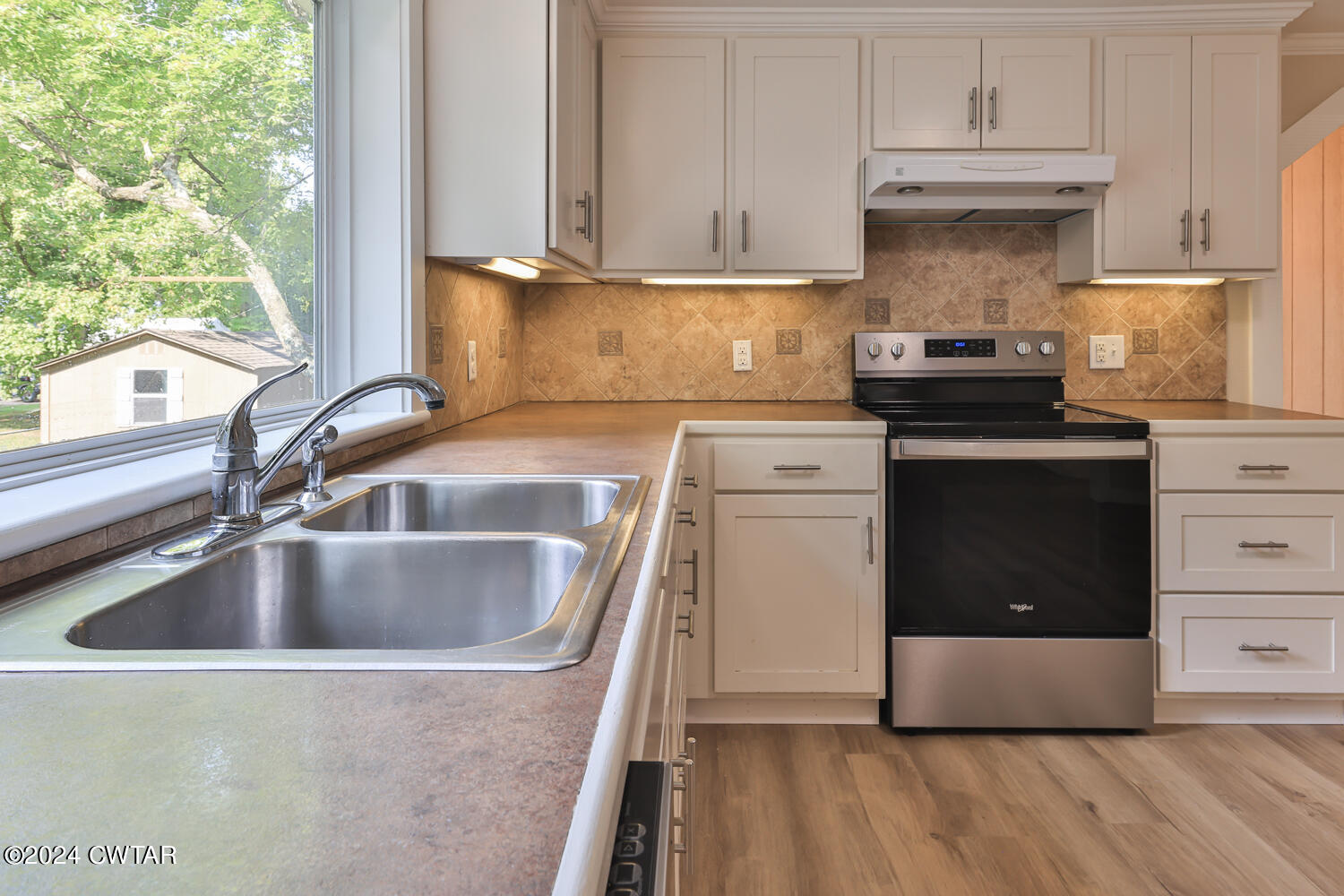246 Thomas Street Dyer, TN 38330 - Photo 8 of 19 a kitchen with granite countertop a sink and a stove next to a window