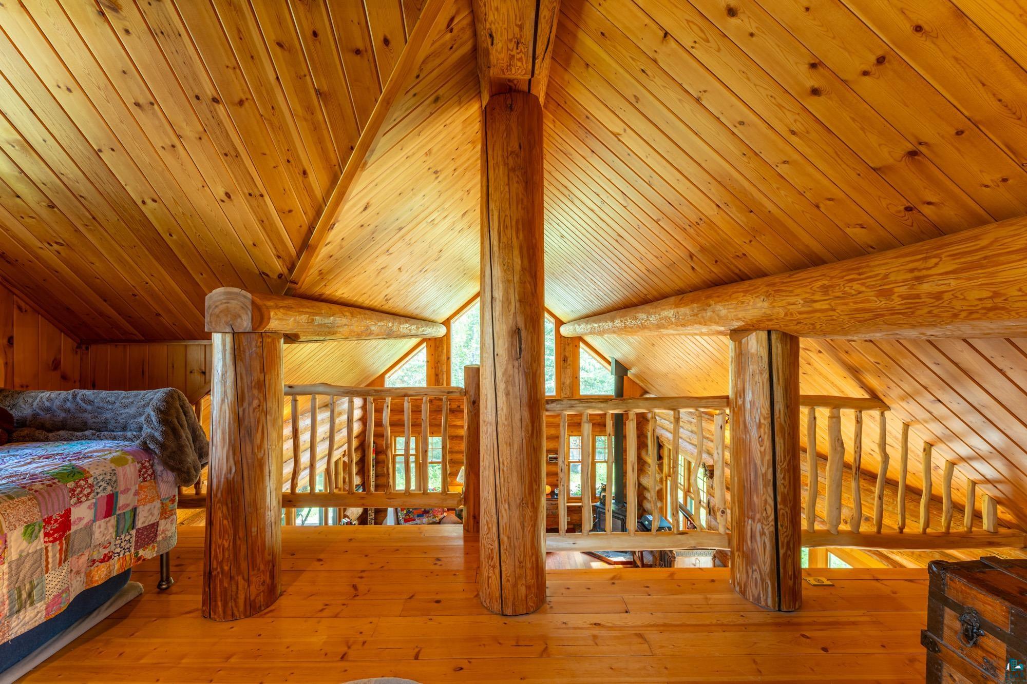 1911 Grouse Ridge Road Ely, MN 55731 - Photo 14 of 42 Bedroom with light hardwood / wood-style floors, vaulted ceiling, and wood ceiling