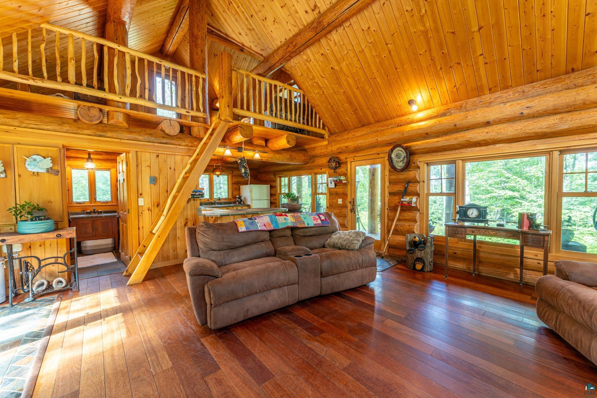 1911 Grouse Ridge Road Ely, MN 55731 - Photo 7 of 42 Living room with wooden ceiling, a wealth of natural light, and wood-type flooring