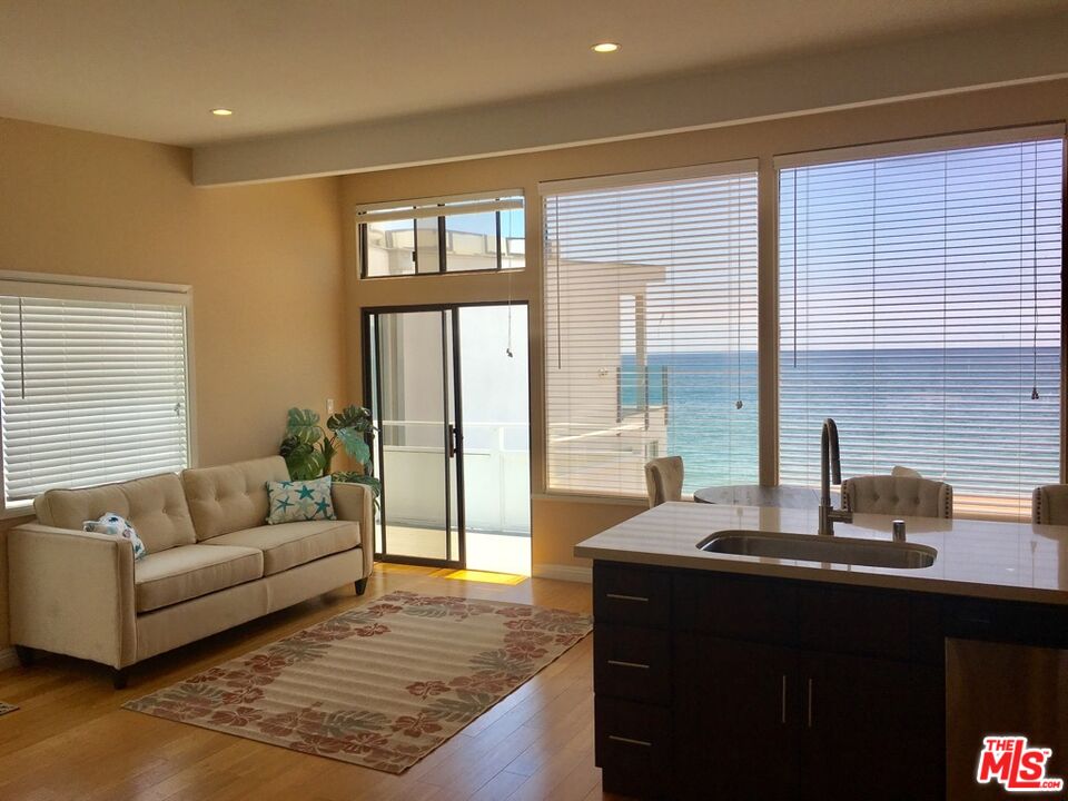 25164 Malibu Road, Unit D Malibu, CA 90265 - Photo 13 of 24 a living room with furniture and large windows