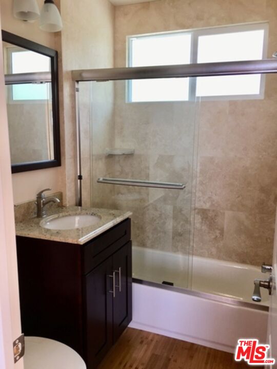 25164 Malibu Road, Unit D Malibu, CA 90265 - Photo 15 of 24 a bathroom with a granite countertop sink a mirror and bathtub