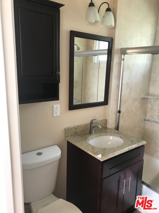 25164 Malibu Road, Unit D Malibu, CA 90265 - Photo 16 of 24 a bathroom with a toilet sink and mirror