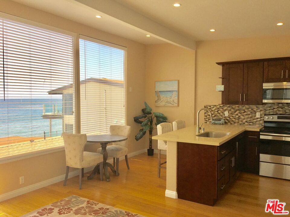 25164 Malibu Road, Unit D Malibu, CA 90265 - Photo 8 of 24 a open kitchen with stainless steel appliances granite countertop a sink and a stove