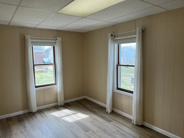 a view of an empty room with wooden floor