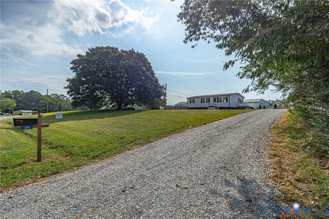 36 Bundick Road Lottsburg, VA 22511 - Photo 48 of 50 Gravel driveway leading to a white residence with