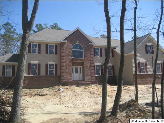 1 Brookside Road Millstone Township, NJ 08510 - Photo 1 of 3 a front view of a house with a yard