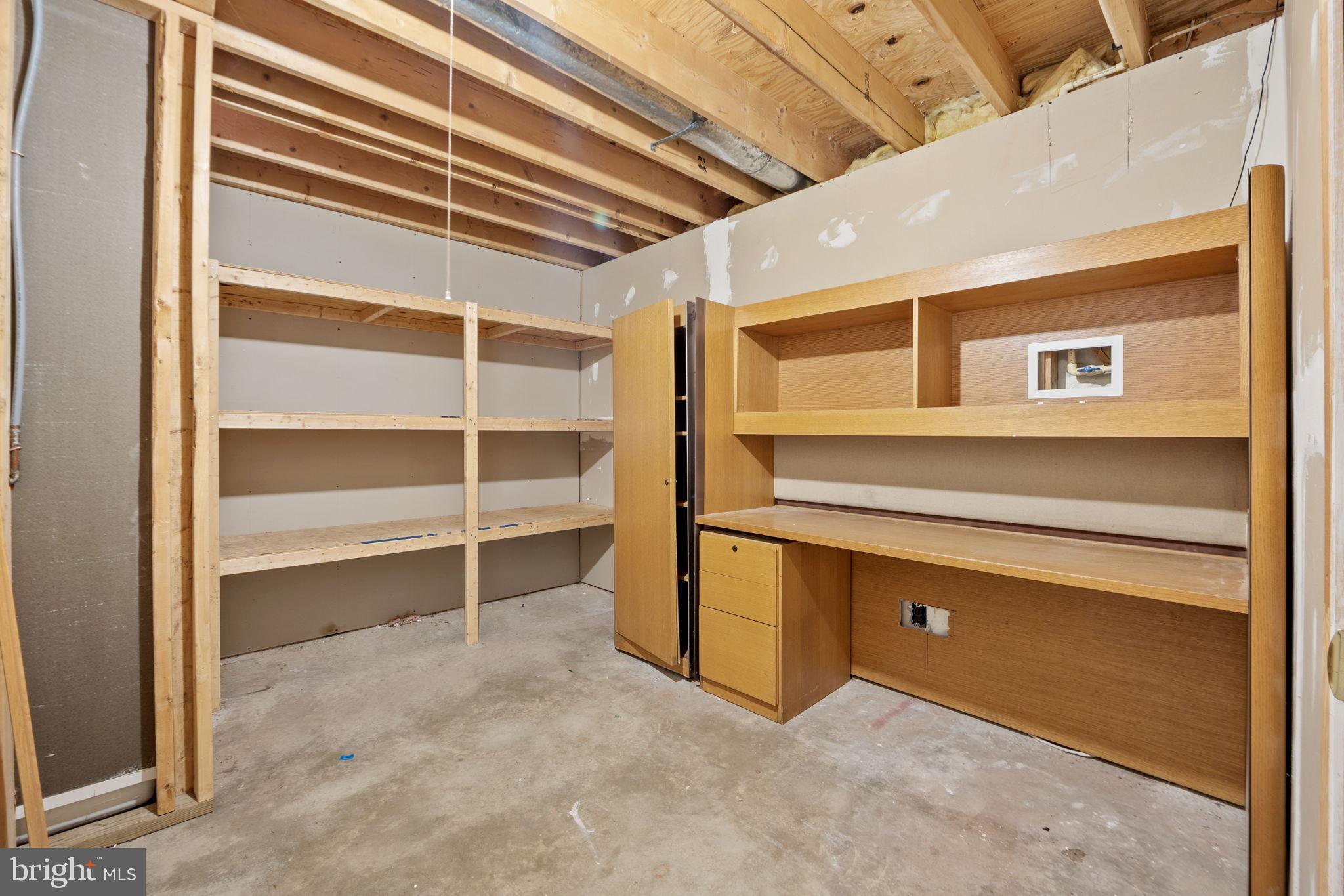 9615 Linden Wood Road Manassas, VA 20111 - Photo 29 of 37 Spacious unfinished room with shelving units.