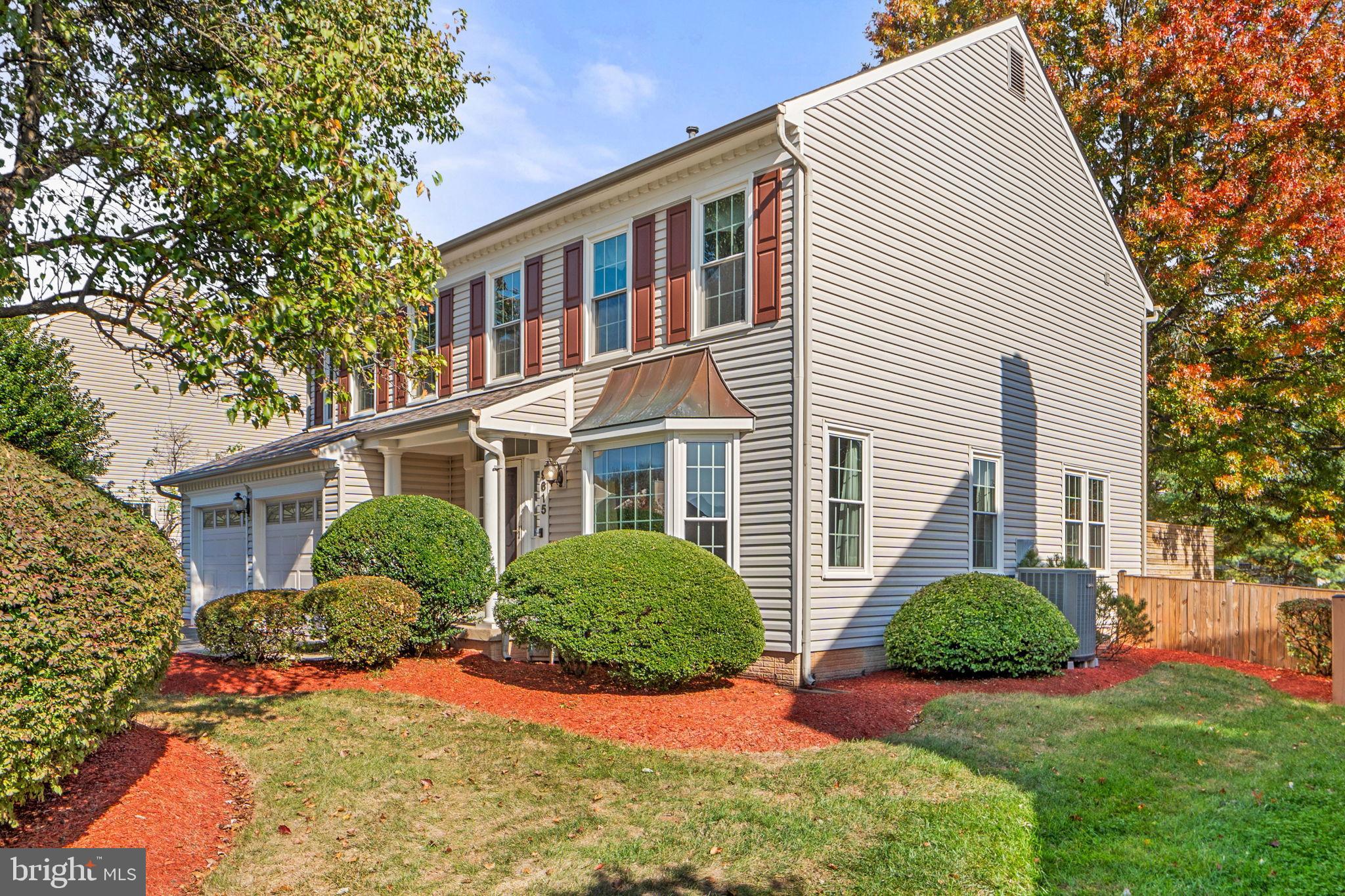 Charming home with vibrant landscaping.