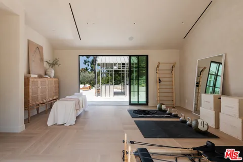 a room with gym equipment and a large window
