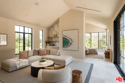 a bedroom with bed and glass walk in closet