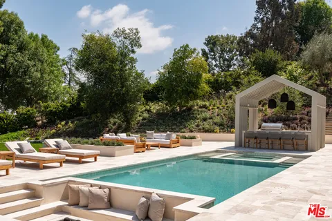 a front view of house with yard swimming pool and outdoor seating