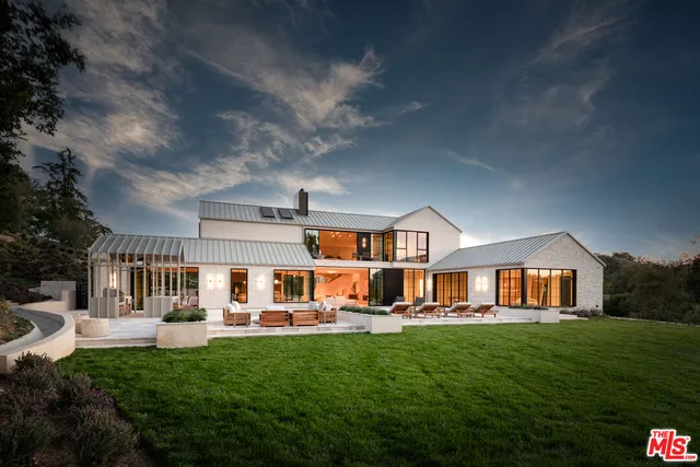 a view of a house with a yard and mountain view