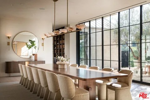 a dining room with furniture a chandelier and wooden floor