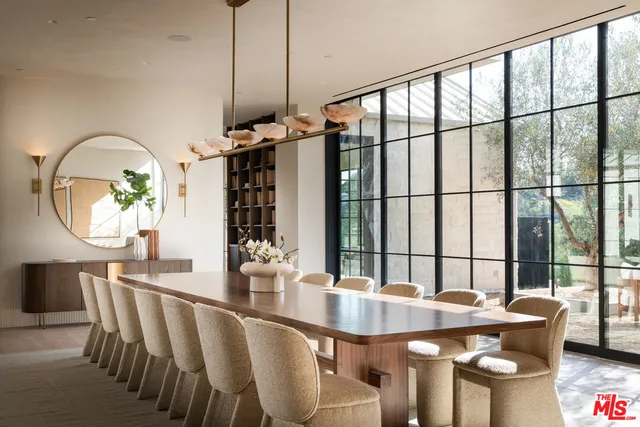a dining room with furniture a chandelier and wooden floor