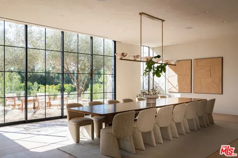 a living room with furniture a chandelier and a dining table